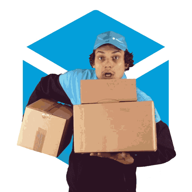 a man wearing a blue hat holds two cardboard boxes in his hands