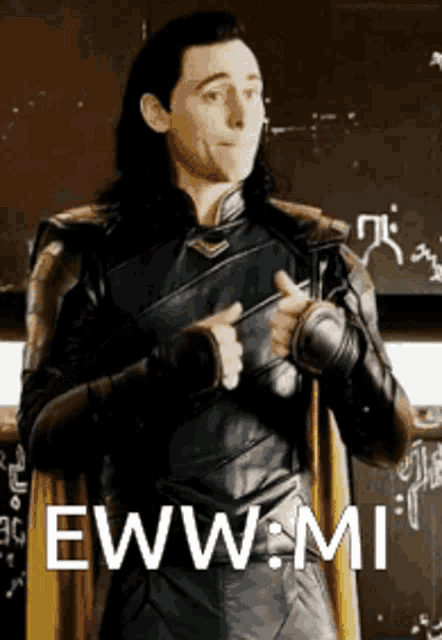 a man in a leather suit is standing in front of a blackboard with the words eww mi written on it