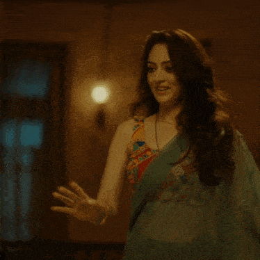 a woman in a crop top is dancing in a room
