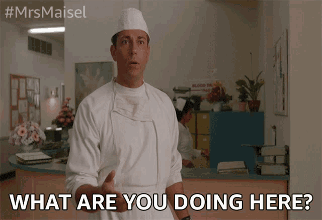 a man in a surgical gown is asking what are you doing here