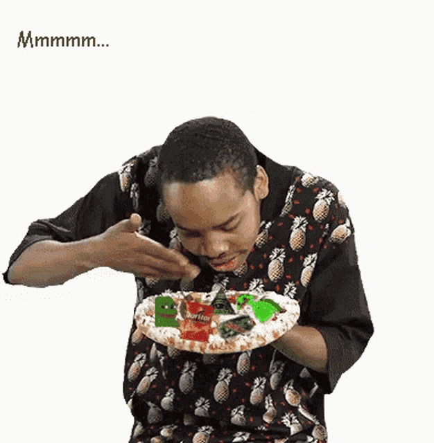 a man wearing a pineapple shirt is holding a pizza and giving an okay sign
