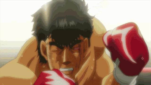 a man wearing red boxing gloves has the letter t on his left hand