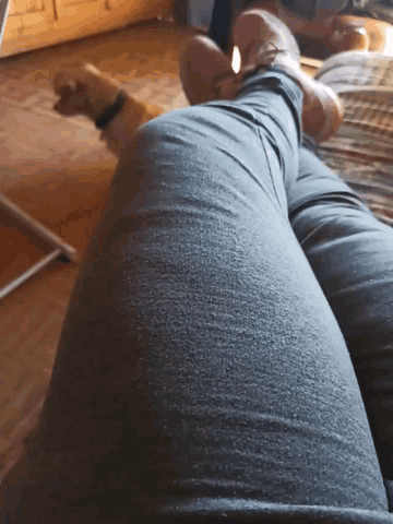 a person laying on a bed with their legs crossed and their feet up