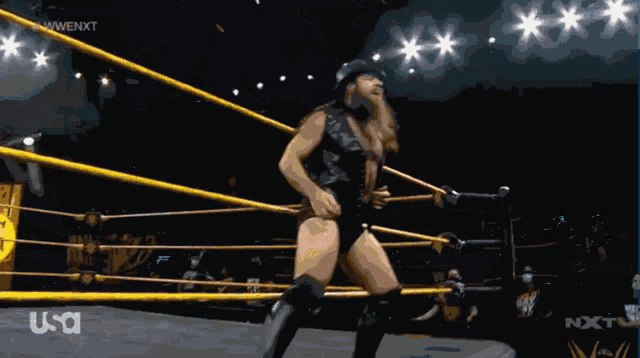 a man in a top hat is in a wrestling ring with the letters nxt on the bottom right