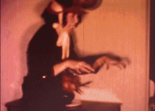 a blurred image of a person holding a bowl in their hand