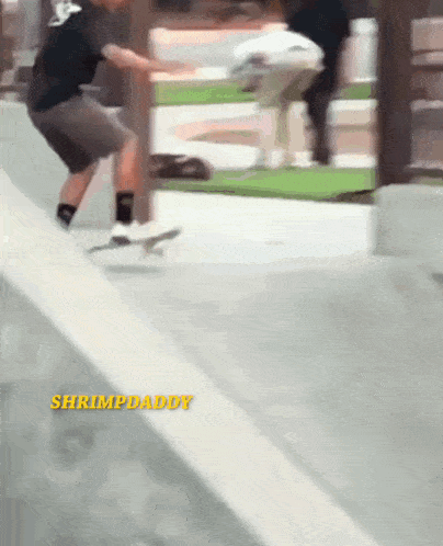 a person riding a skateboard on a ramp with shrimpdaddy written in yellow