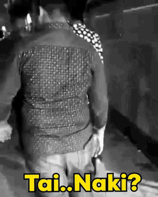 a black and white photo of a man kneeling down with the words tai.naki written on the bottom