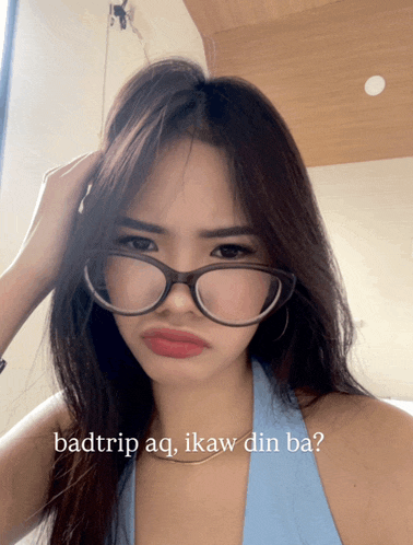 a woman wearing glasses with the words badtrip aq ikaw din ba written below her