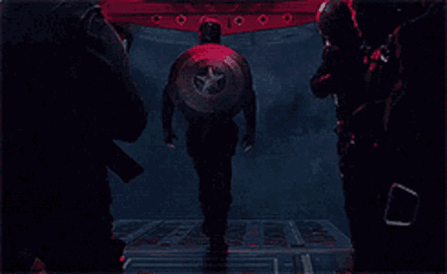 a man with a shield on his back is walking out of a doorway