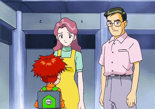 a man and a woman are standing next to a boy with a green case