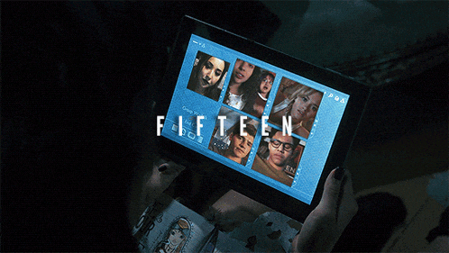 a person is holding a tablet that says fifteen on the screen