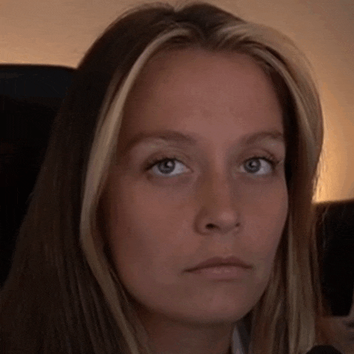 a close up of a woman 's face with her eyes closed