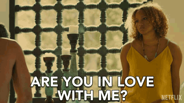 a woman in a yellow tank top is asking if she is in love with a man