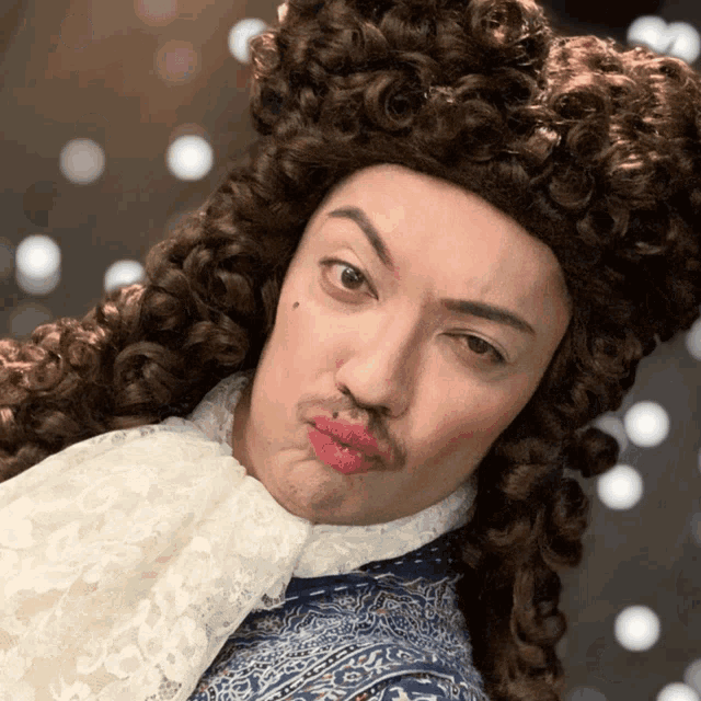 a man with curly hair and a mustache is wearing a wig and making a face
