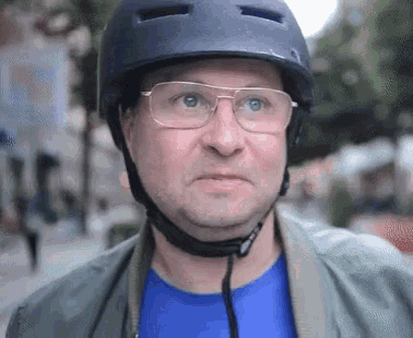 a man wearing a helmet and glasses makes a funny face