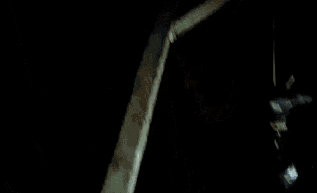 a man is hanging upside down on a ladder .