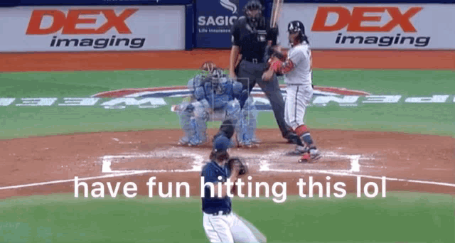 a baseball game is being played in front of a dex imaging banner