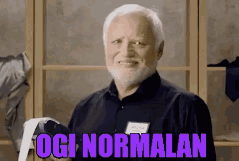a man with a beard is smiling and holding a piece of paper that says ogi normalan