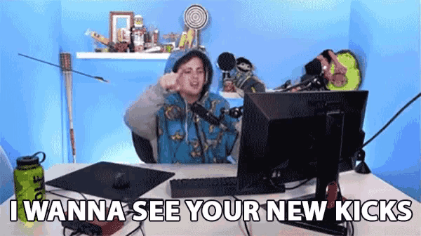 a person sitting in front of a computer with the words " i wanna see your new kicks " on the bottom
