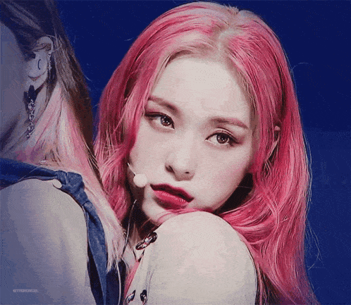 a close up of a woman 's face with pink hair and the words bittersweet on the bottom
