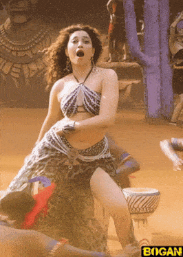 a woman is dancing in front of a sign that says " bogan "