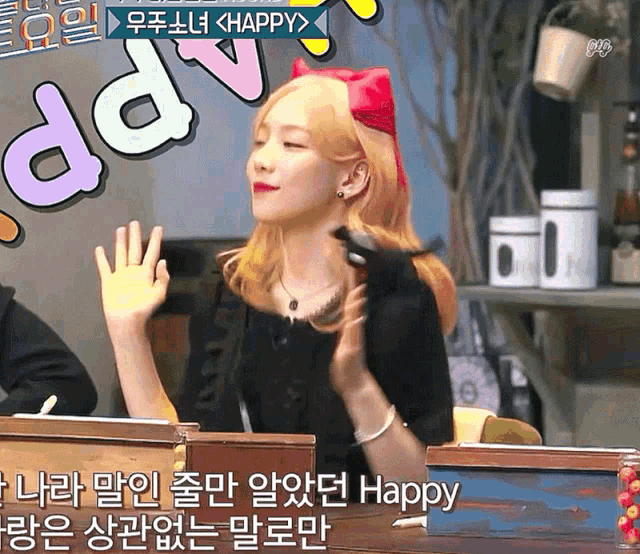 a woman sitting at a desk with a sign that says happy on it