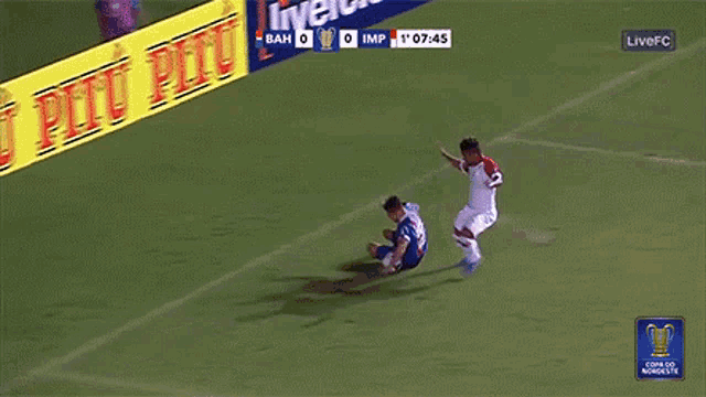 a soccer game is being played in front of an advertisement for pitu pitu