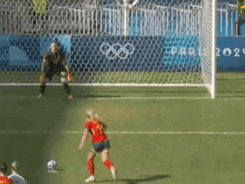 a soccer player wearing a number 23 jersey is kicking a ball