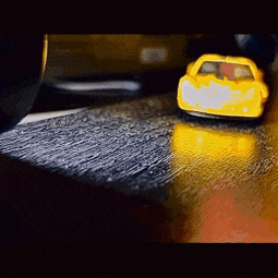 a yellow toy car is sitting on a table