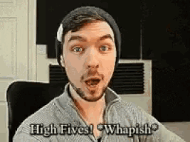 a man with a beard wearing a beanie says high fives whipish