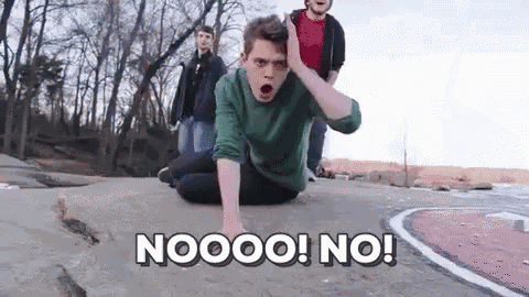 a man in a green shirt is kneeling on the ground with his hand on his head and the words nooo ! no ! above him
