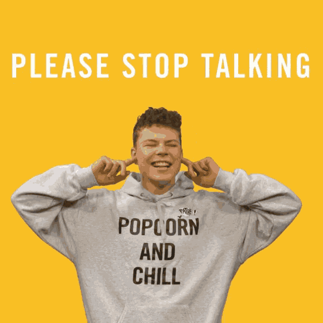a man wearing a hoodie that says popcorn and chill is covering his ears