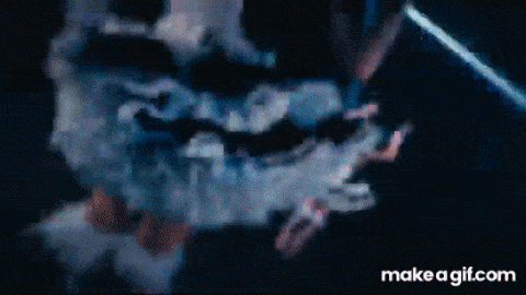 a group of people are dancing in a dark room in front of a crowd .