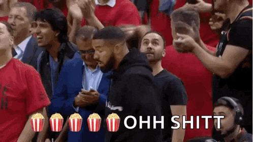 a crowd of people watching a basketball game with popcorn and the words ohh shitt