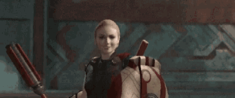 a woman is holding a red and white shield and a spear