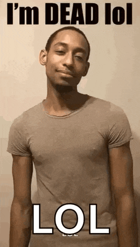 a man in a t-shirt is standing in front of a wall with the words i 'm dead lol lol .