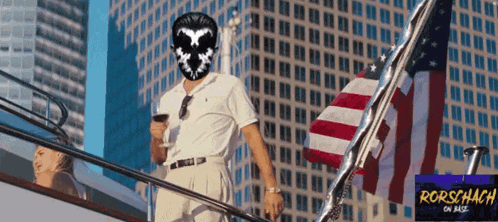 a man wearing a mask stands on a boat with a rorschach on base logo in the corner