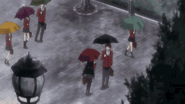 a group of people with umbrellas are walking down a sidewalk