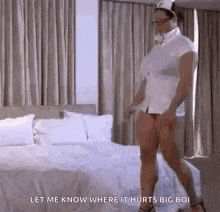 a woman dressed as a nurse is standing on a bed in a bedroom .