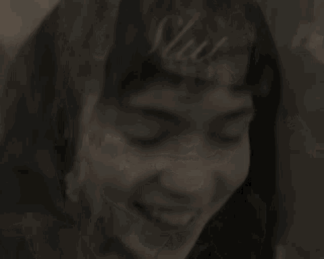 a close up of a woman 's face smiling