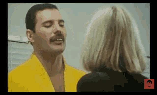 a man in a yellow robe is looking at a woman