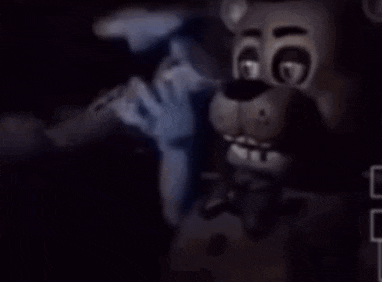 a teddy bear is holding a microphone in the dark .