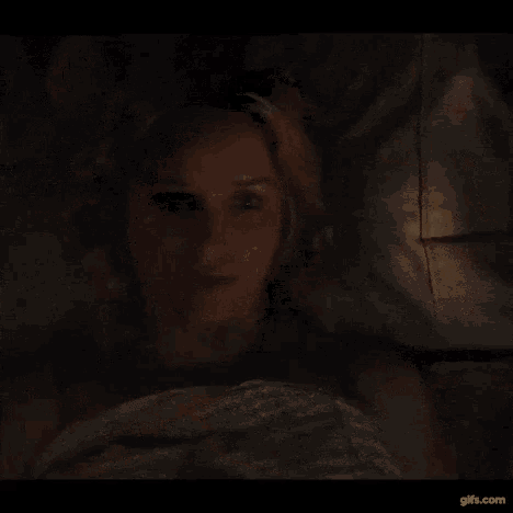 a woman is laying on a bed with a man .