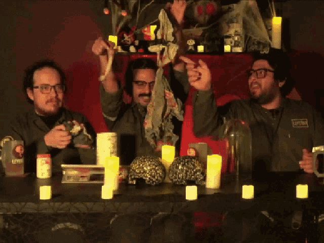 a group of men are sitting at a table with candles and a can that says lefty on it