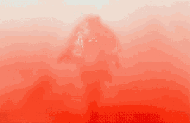 a person is walking through a red foggy area