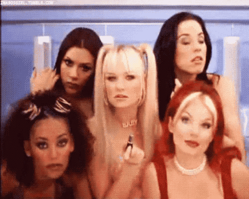 a group of women are standing next to each other .