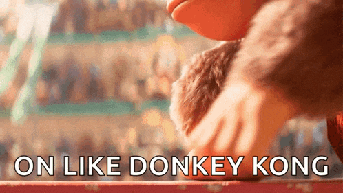 a close up of a person petting a stuffed animal with the words on like donkey kong