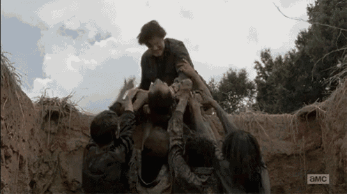 a group of people are holding a man in a pile of dirt with the letters a and mc on the bottom