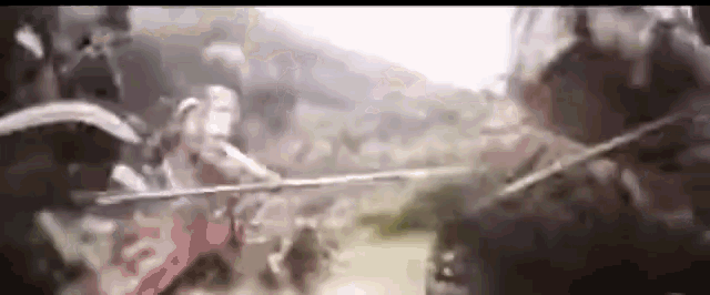 a blurry picture of a group of soldiers fighting each other .