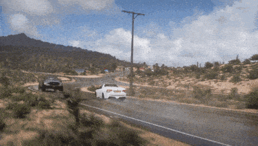 two cars are driving down a desert road and one of them has a license plate that says ' jcv ' on it
